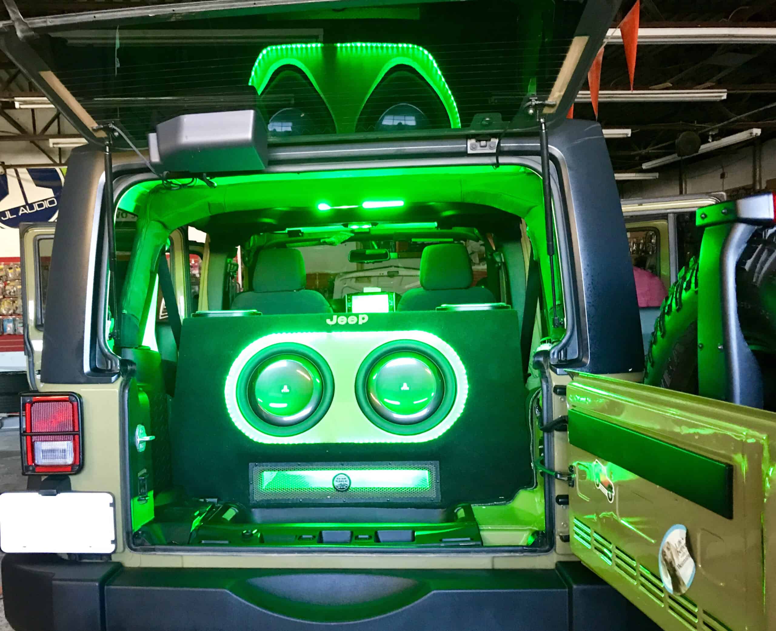 A Jeep, with a powerful car audio system and customized lighting.